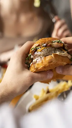 Homme qui tient un hamburger